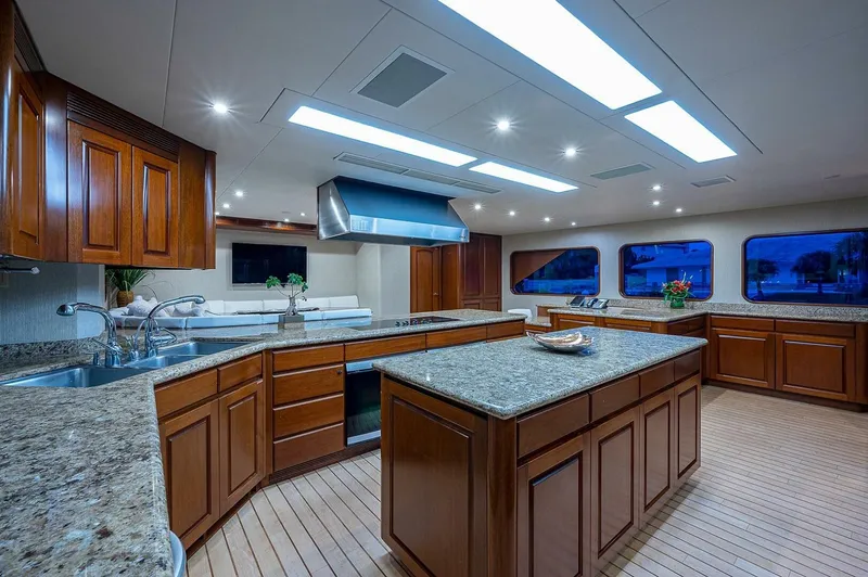 La Sirena Yacht Photos Pics Luxurious kitchen interior on 2000 Christensen 141 Raised Pilothouse yacht with wooden cabinetry.