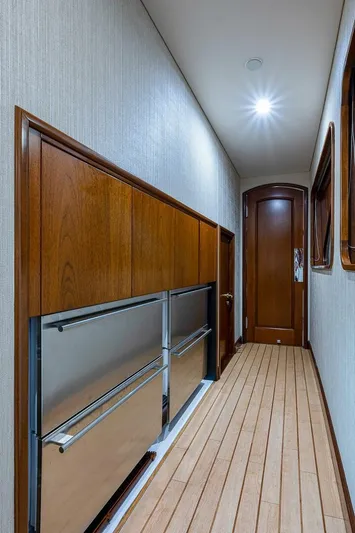 La Sirena Yacht Photos Pics Luxurious hallway in 2000 Christensen 141 Raised Pilothouse yacht with wood paneling and modern lighting.