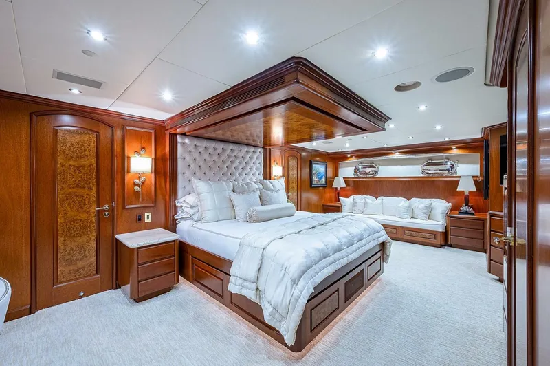 La Sirena Yacht Photos Pics Luxurious bedroom interior on 2000 Christensen 141 Raised Pilothouse yacht, featuring elegant wood finishes.