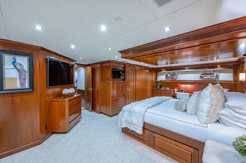 La Sirena Yacht Photos Pics Luxurious bedroom interior of 2000 Christensen 141 Raised Pilothouse yacht with elegant wood finishes.