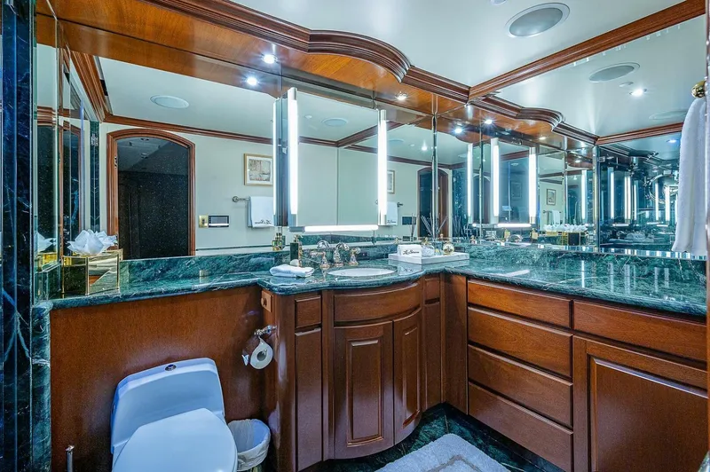 La Sirena Yacht Photos Pics Luxurious bathroom with wood cabinetry and marble countertops on a 2000 Christensen 141 Raised Pilothouse yacht.