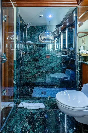 La Sirena Yacht Photos Pics Luxurious yacht bathroom with green marble, glass shower, and modern fixtures on Christensen 141 Raised Pilothouse.