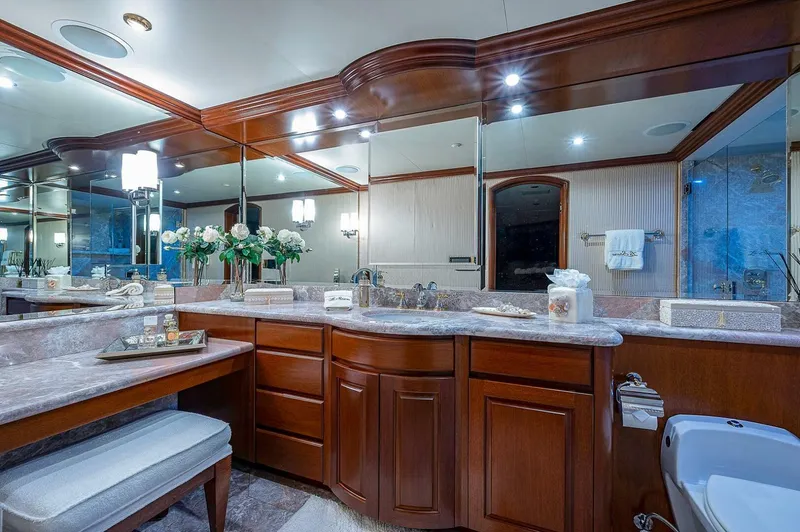 La Sirena Yacht Photos Pics Luxurious yacht bathroom with wooden cabinetry, marble countertops, and elegant lighting on Christensen 141 Raised Pilothouse.