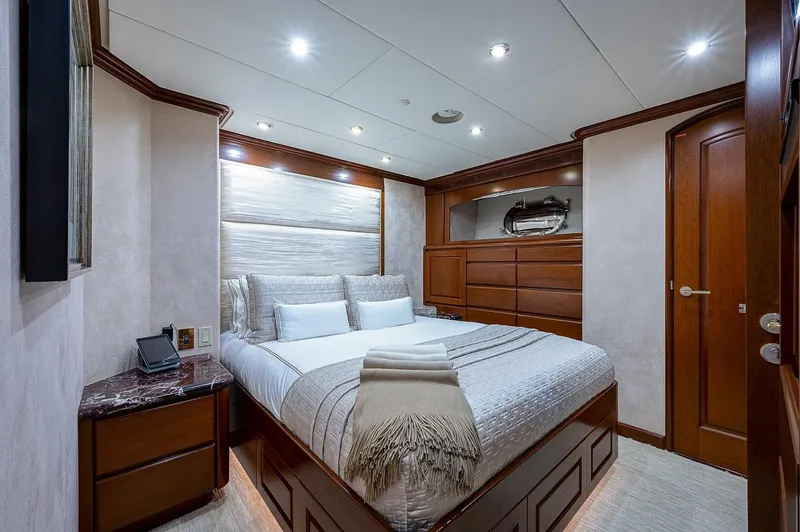 La Sirena Yacht Photos Pics Luxurious bedroom interior on 2000 Christensen 141 Raised Pilothouse yacht, featuring elegant wood finishes.