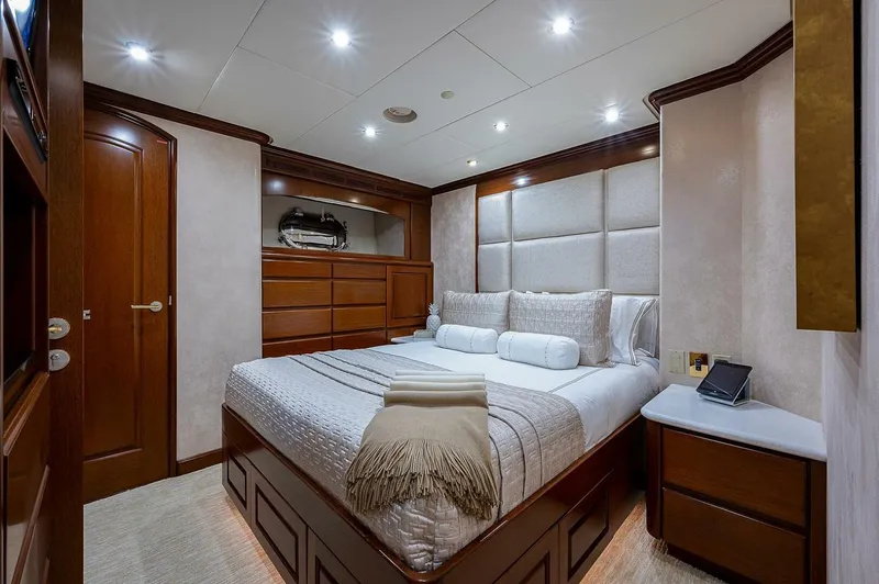 La Sirena Yacht Photos Pics Luxurious bedroom interior on 2000 Christensen 141 Raised Pilothouse yacht, featuring elegant wood finishes.