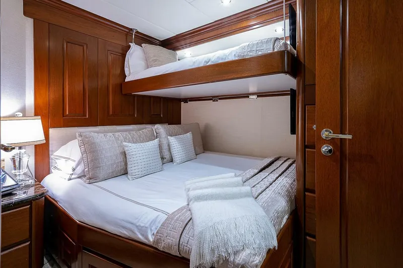 La Sirena Yacht Photos Pics Luxurious cabin interior with wooden paneling and cozy bedding on Christensen 141 Raised Pilothouse yacht.