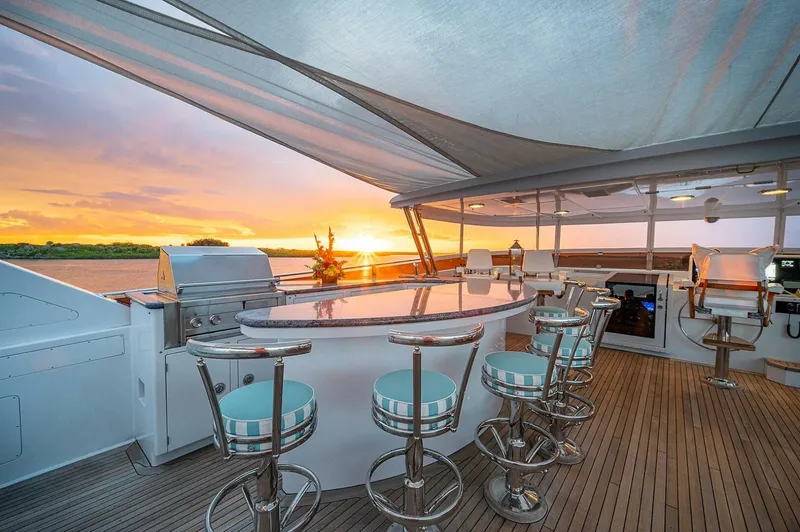 La Sirena Yacht Photos Pics Luxurious yacht deck with bar seating, sunset view; Christensen 141 Raised Pilothouse, 2000 model.