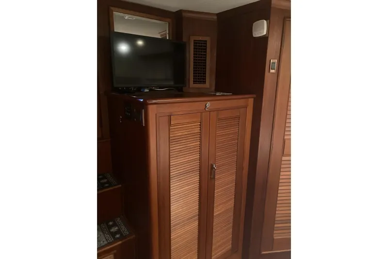 Gb421500 Yacht Photos Pics Interior of 2002 Grand Banks 42 Classic with wooden cabinetry and mounted TV.