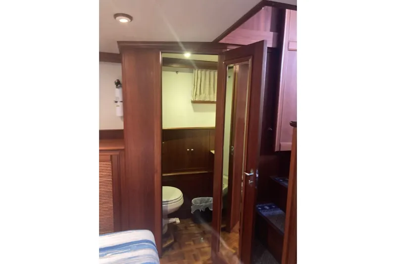 Gb421500 Yacht Photos Pics Interior of 2002 Grand Banks 42 Classic yacht, featuring wooden cabinetry and a compact bathroom.