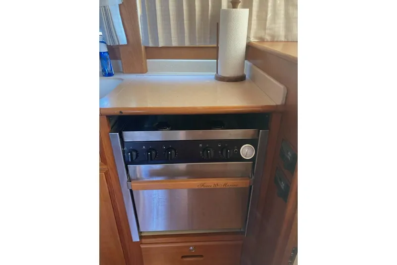 Gb421500 Yacht Photos Pics Galley kitchen in 2002 Grand Banks 42 Classic yacht with stove and paper towel holder.