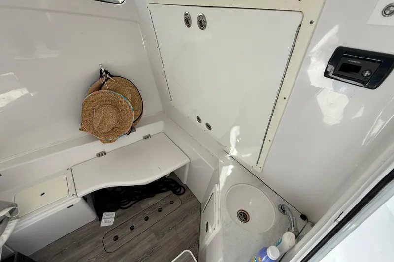  Yacht Photos Pics 2020 Sportsman Open 352 Center Console interior with storage, sink, and hanging hats.