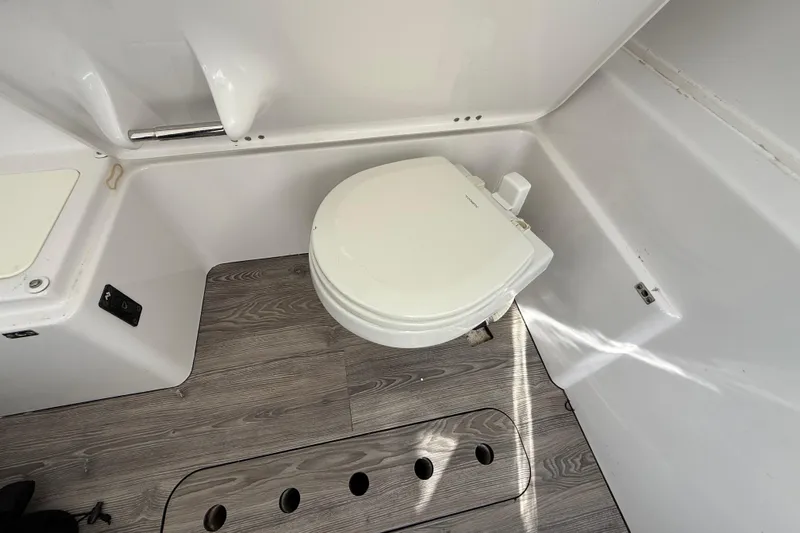  Yacht Photos Pics 2020 Sportsman Open 352 Center Console boat bathroom with toilet and wood-patterned flooring.