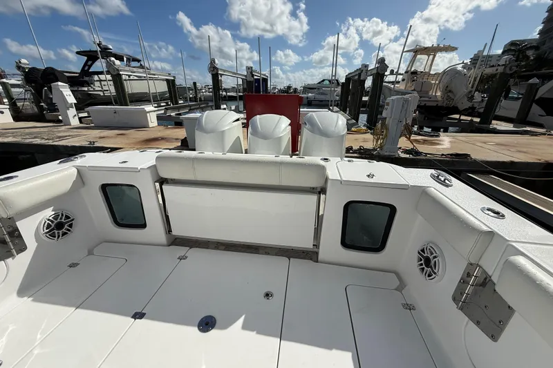  Yacht Photos Pics 2020 Sportsman Open 352 Center Console boat docked, featuring spacious deck and triple engines.