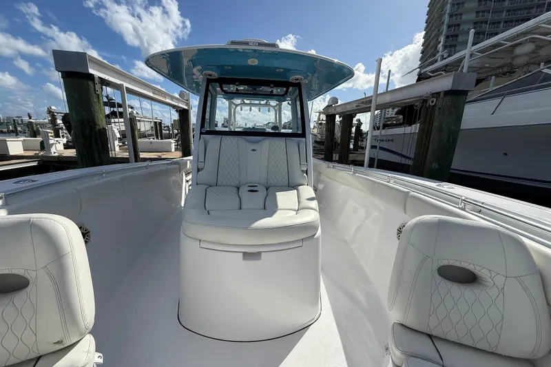  Yacht Photos Pics 2020 Sportsman Open 352 Center Console boat with white seating, docked under blue sky.