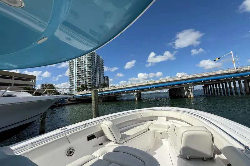  Yacht Photos Pics 2020 Sportsman Open 352 Center Console boat near a bridge, under clear blue skies.
