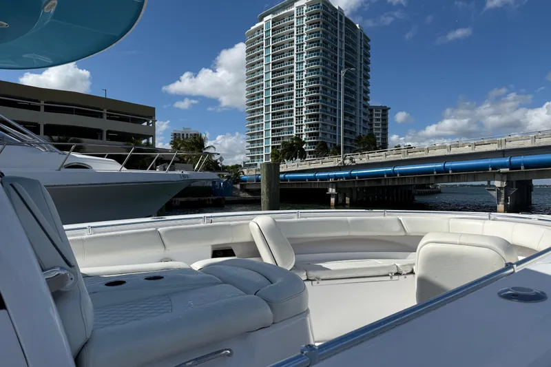  Yacht Photos Pics 2020 Sportsman Open 352 Center Console boat docked near a bridge and high-rise building.