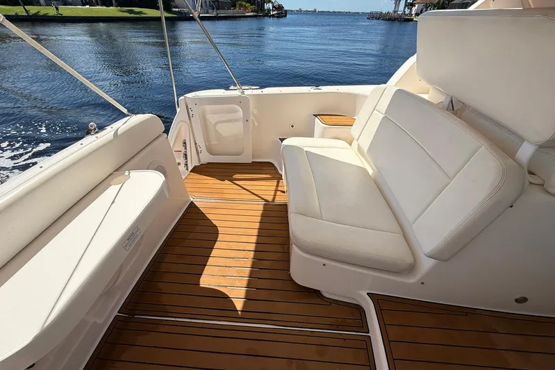 Blue Skys Yacht Photos Pics 2005 Tiara Yachts 3600 Sovran cockpit with white seating and wooden deck.