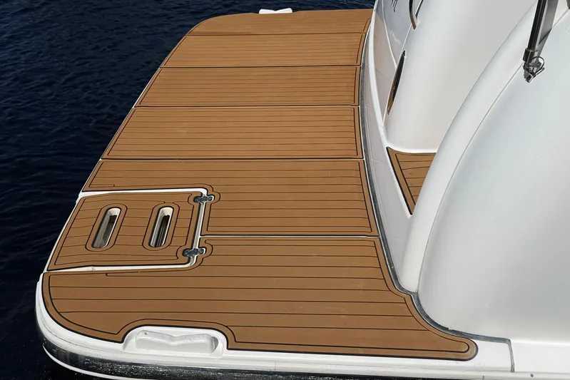 Blue Skys Yacht Photos Pics 2005 Tiara Yachts 3600 Sovran swim platform with teak decking, docked on calm water.