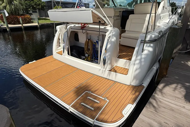 Blue Skys Yacht Photos Pics 2005 Tiara Yachts 3600 Sovran with teak swim platform and open cockpit, docked by water.