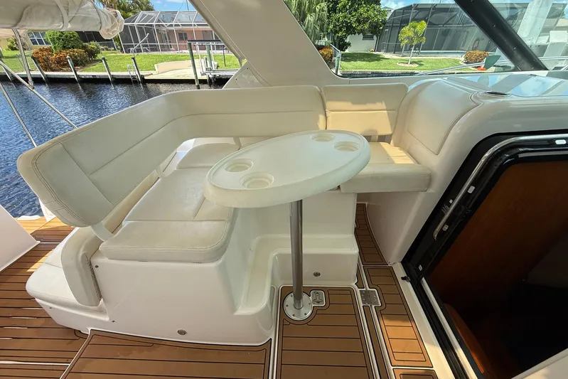 Blue Skys Yacht Photos Pics 2005 Tiara Yachts 3600 Sovran interior with white seating and round table.