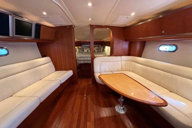 Blue Skys Yacht Photos Pics Luxurious interior of 2005 Tiara Yachts 3600 Sovran with elegant seating and wooden finishes.