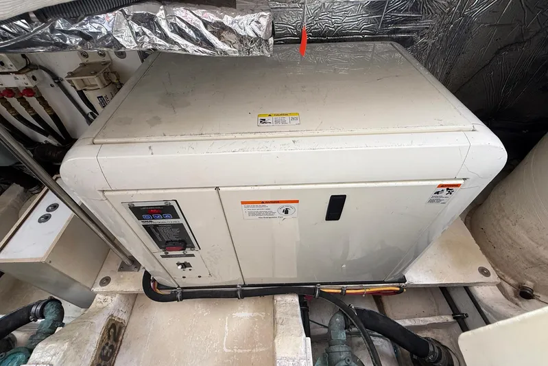 Blue Skys Yacht Photos Pics Engine compartment of a 2005 Tiara Yachts 3600 Sovran, featuring a generator unit.