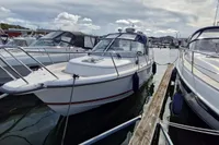 Nimbus 27 Nova S 2008 boat docked at marina, surrounded by other vessels.