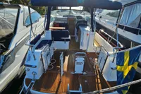 2008 Nimbus 27 Nova S boat with Swedish flag, wooden deck, and seating area.