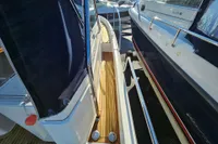 Side view of a 2008 Nimbus 27 Nova S boat with wooden deck and railing.