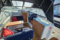 Interior of 2008 Nimbus 27 Nova S boat with seating, table, and helm.