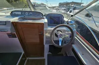 Steering console of 2008 Nimbus 27 Nova S boat with gauges and controls.