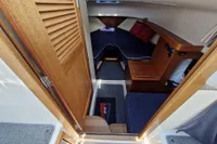 Interior of 2008 Nimbus 27 Nova S boat with wooden finishes and blue seating.