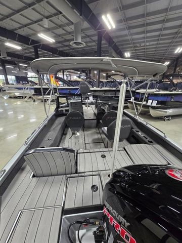 2024 Vexus ADX180 boat with Mercury engine, showcased indoors, featuring spacious seating and canopy.