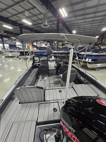 2024 Vexus ADX180 boat with Mercury engine, showcased indoors, featuring spacious seating and canopy.