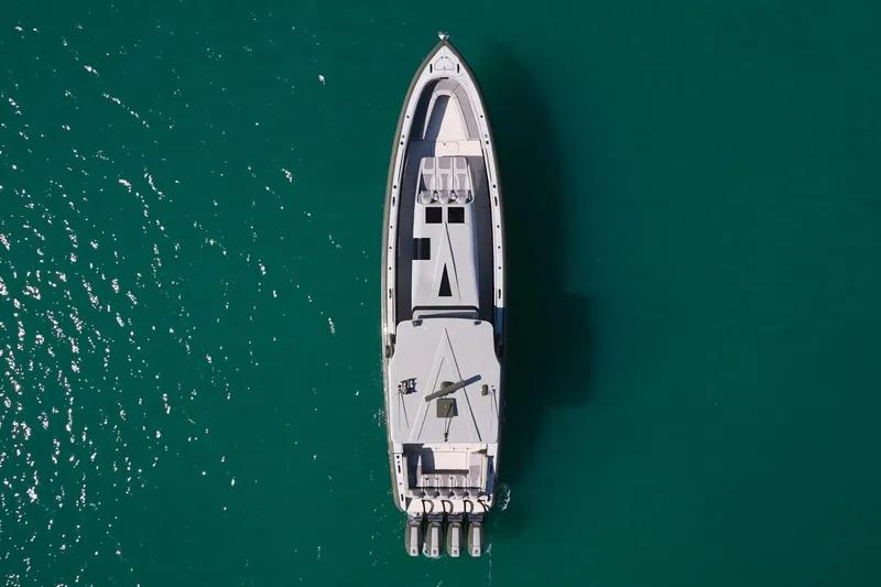  Yacht Photos Pics Aerial view of 2025 Midnight Express 52' Vitesse yacht on turquoise water.
