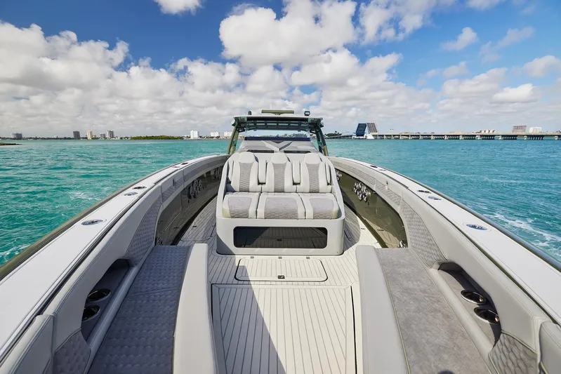  Yacht Photos Pics 2025 Midnight Express 52' Vitesse luxury boat on turquoise water under blue sky.
