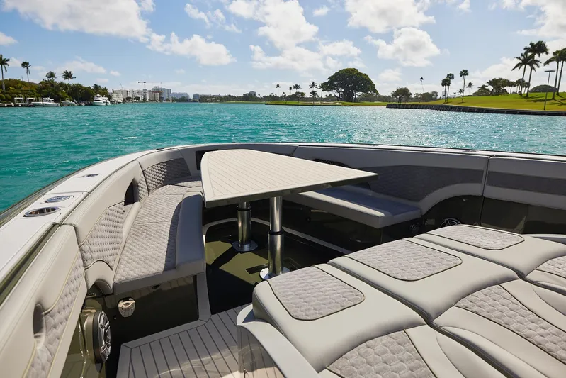  Yacht Photos Pics Luxurious 2025 Midnight Express 52' Vitesse yacht interior with elegant seating and table, overlooking serene waters.