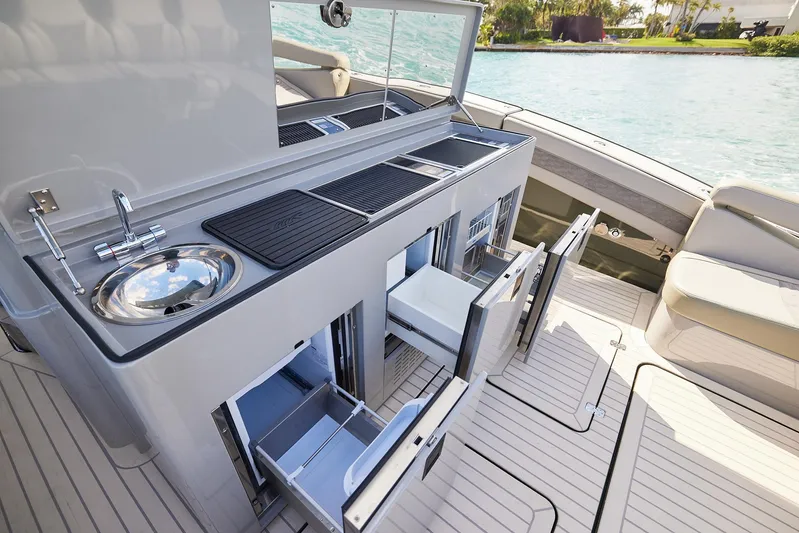 Yacht Photos Pics Luxurious 2025 Midnight Express 52' Vitesse yacht with sleek outdoor kitchen setup.