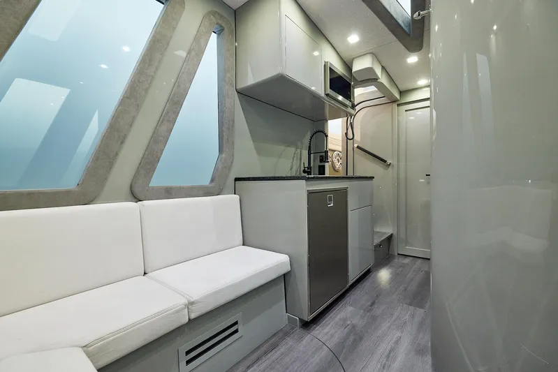  Yacht Photos Pics Modern interior of 2025 Midnight Express 52' Vitesse yacht with sleek kitchen and seating area.