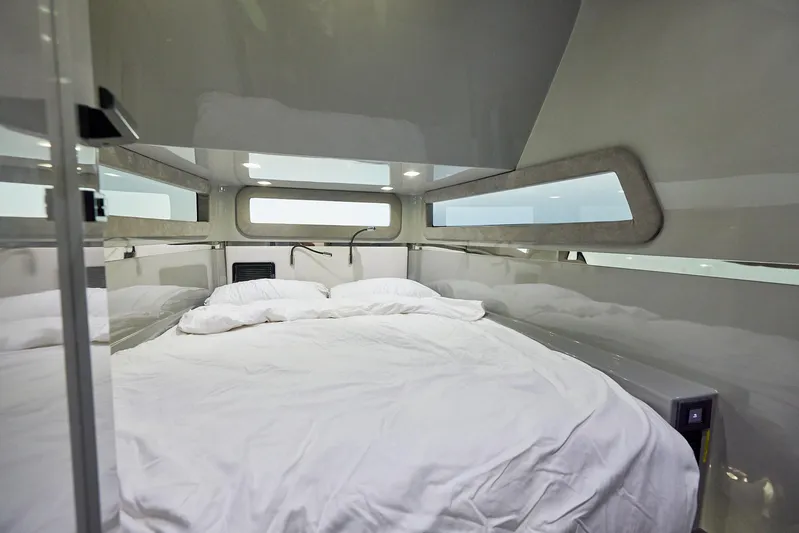  Yacht Photos Pics Luxurious cabin interior of 2025 Midnight Express 52' Vitesse yacht with cozy bedding.