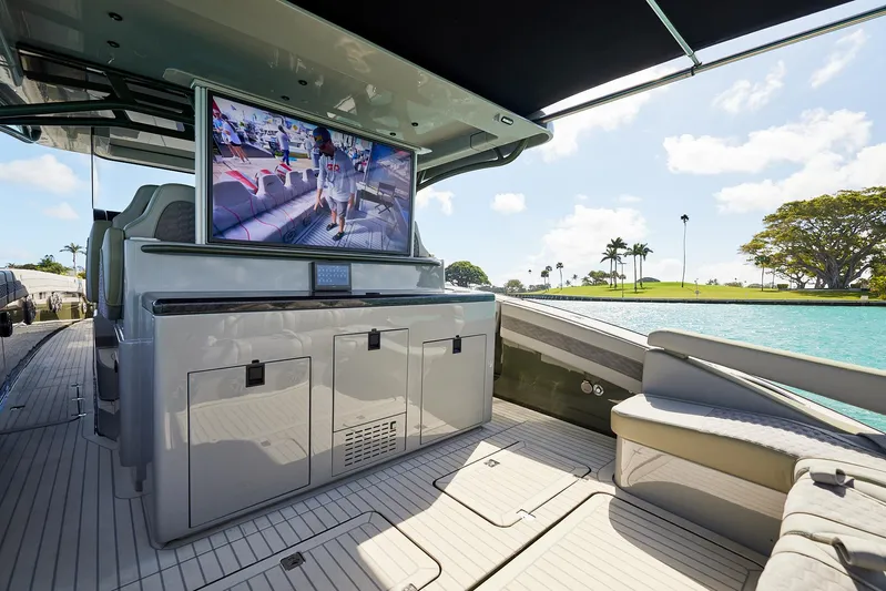  Yacht Photos Pics Luxurious 2025 Midnight Express 52' Vitesse yacht interior with TV and scenic water view.