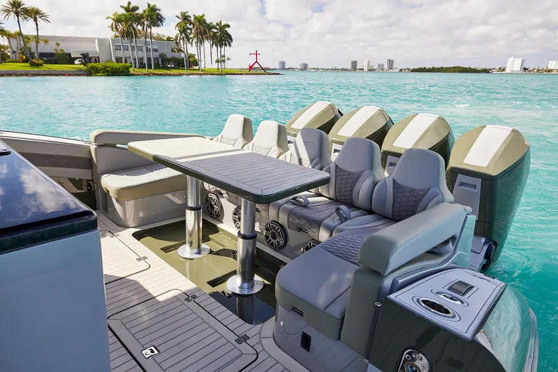  Yacht Photos Pics Luxury seating area on 2025 Midnight Express 52' Vitesse yacht, overlooking turquoise waters.