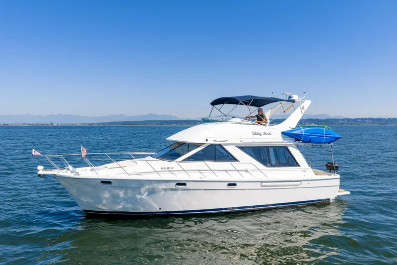  Yacht Photos Pics 1997 Bayliner 3988 yacht cruising on open water under clear blue sky.