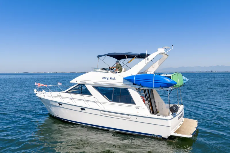  Yacht Photos Pics 1997 Bayliner 3988 yacht cruising on open water under clear blue skies.