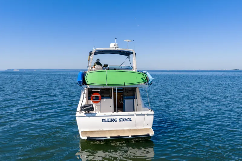  Yacht Photos Pics 1997 Bayliner 3988 yacht on open water, featuring a green kayak on deck.