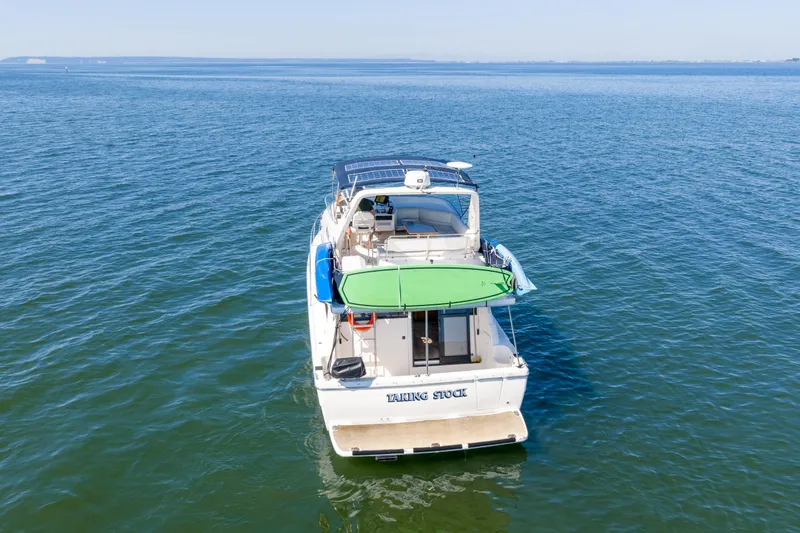  Yacht Photos Pics 1997 Bayliner 3988 yacht on open water, featuring a green canopy and solar panels.