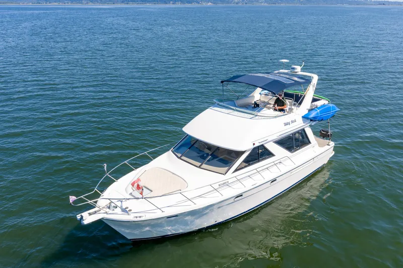  Yacht Photos Pics 1997 Bayliner 3988 yacht cruising on open water under clear skies.