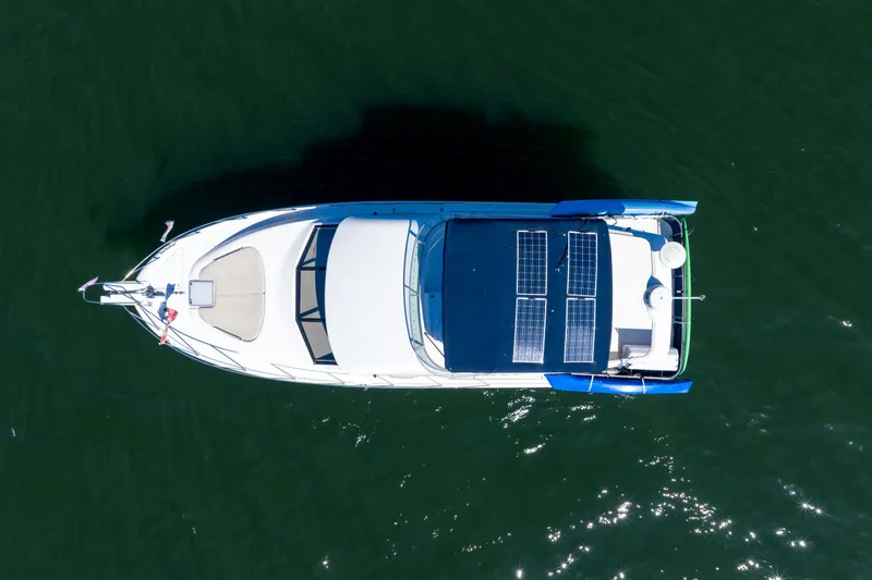  Yacht Photos Pics Overhead view of a 1997 Bayliner 3988 boat with solar panels on water.