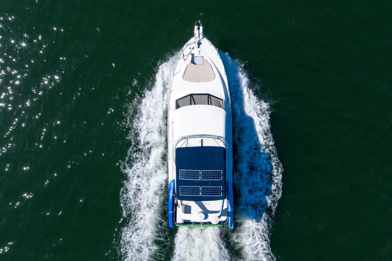  Yacht Photos Pics Aerial view of 1997 Bayliner 3988 yacht cruising on water with solar panels.