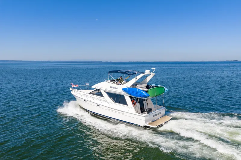  Yacht Photos Pics 1997 Bayliner 3988 yacht cruising on open water under clear blue skies.